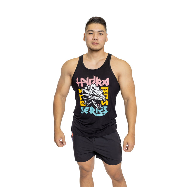 A man with short dark hair wears a black Bells of Steel Bamboo Tank Top featuring colorful text and a dragon graphic, paired with black shorts, standing facing forward against a white background.