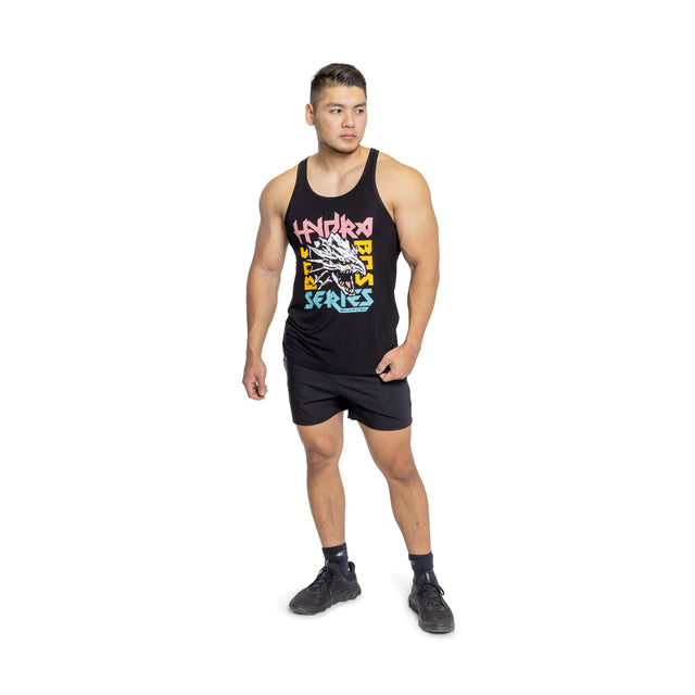 A man wearing a Bells of Steel Bamboo Tank Top, paired with black shorts and black athletic shoes, stands looking to the side against a white background.