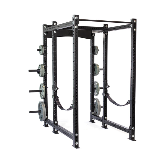 The Bells of Steel Hydra Six Post Power Rack Builder (3" x 3", ⅝" Holes) is a black metal rack with weight plates on side pegs, adjustable safety straps, modular components, and multiple holes for bar placement customization.