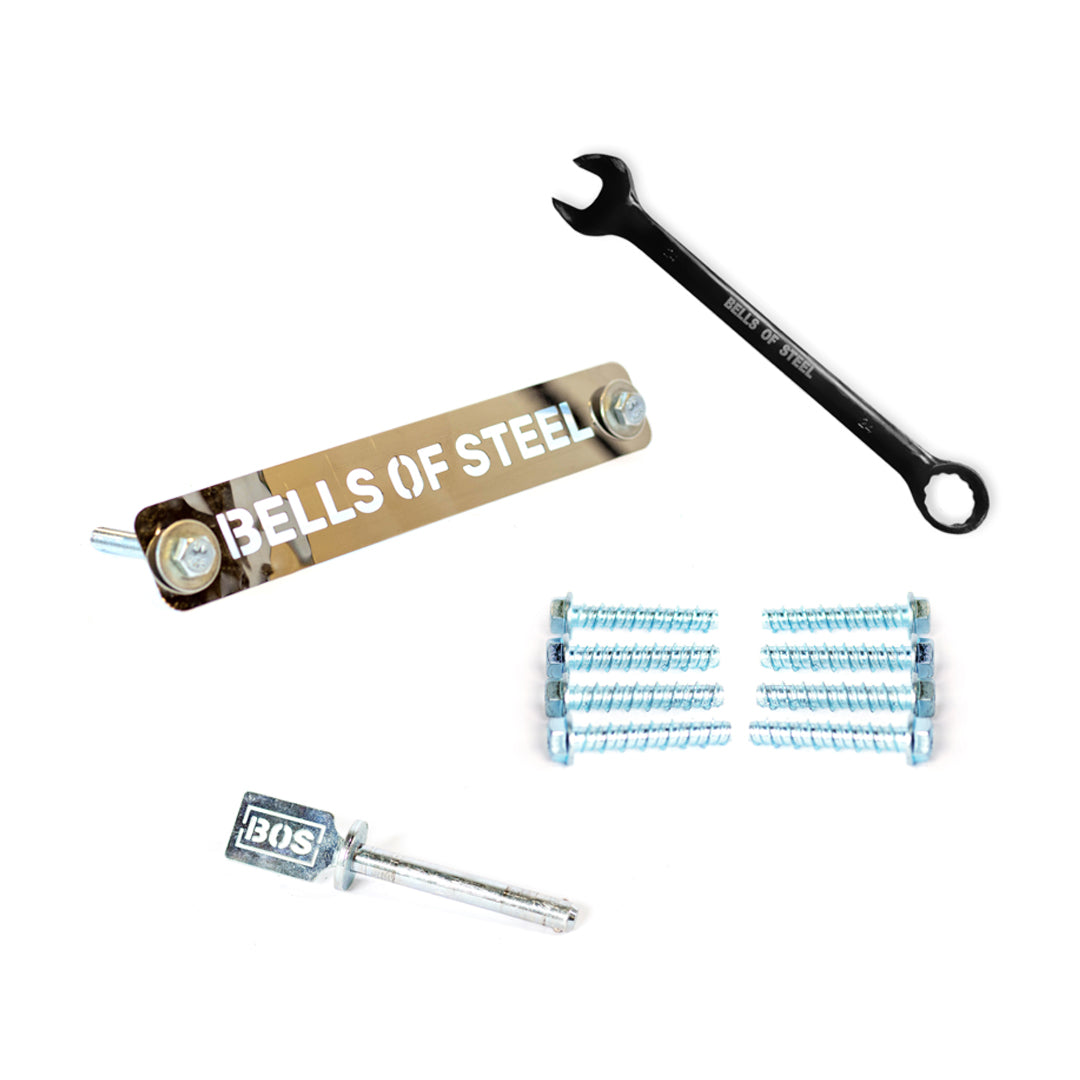 The Bells of Steel Hydra Hardware set includes a metal nameplate, black wrench, BOS handle, Smith Machine adapters, Hydra rack bolts, and concrete anchor bolts, all arranged neatly on a white background.