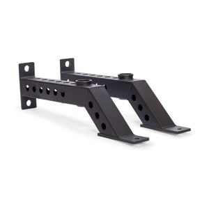The Bells of Steel Front Foot Stabilizers are two black metal brackets with multiple holes, angled sections, and flat mounting plates at both ends, designed to add support or enable barbell storage on your power rack.