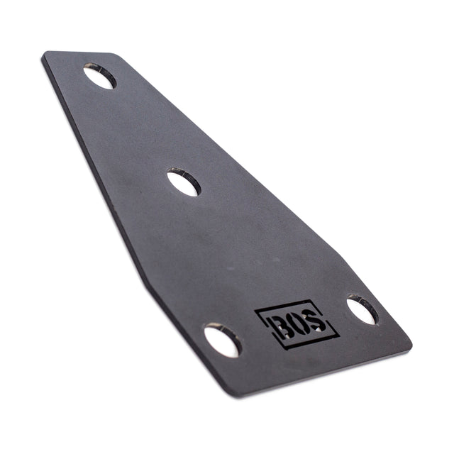 The black flat metal bracket from Bells of Steel, compatible with Manticore power racks, features three circular holes and a cut-out design near one end. Its tapered shape elegantly provides sleek support for your setup.
