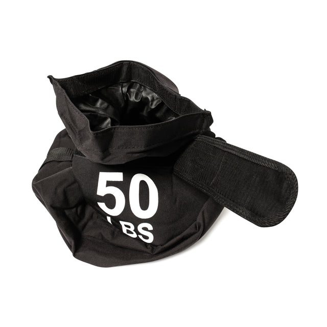 The Bells of Steel Fitness Sandbag Sets feature a black, open-top sandbag with a Velcro strap and bold white "50 LBS" label, crafted from durable Condura—ideal for intense workouts. Shown against a clean white background.