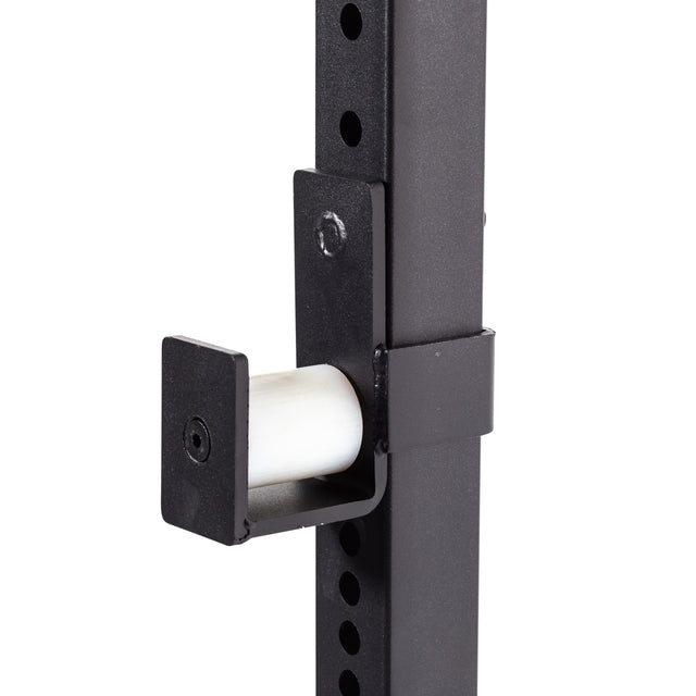 Close-up of the Bells of Steel Light Commercial Power Rack (2.3" x 2.3", ⅝" HOLES) upright in black metal, featuring a J-cup attachment with white barbell protector and multiple adjustment holes—ideal for home workouts.