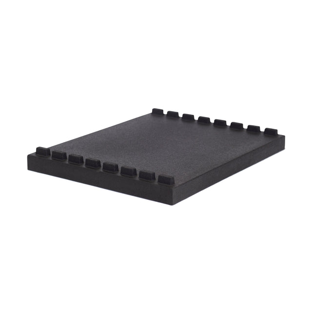 The Bells of Steel Stackable Pull Blocks are rectangular black foam pads with a tongue and groove design and evenly spaced rectangular grooves along two edges, shown on a white background.