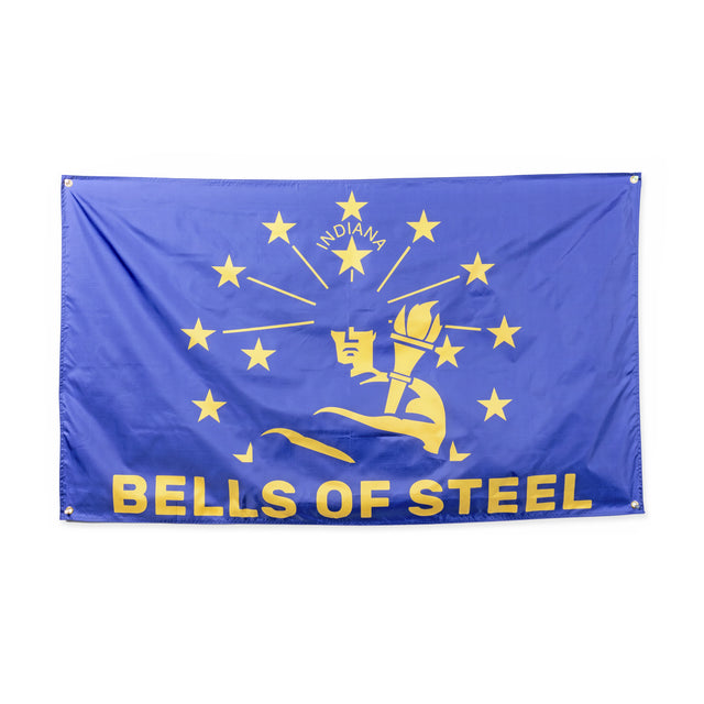 The Bells of Steel Flags feature a blue design with yellow stars, a torch, "INDIANA" at the top, and "BELLS OF STEEL" at the bottom—perfect state-inspired decor for any home gym.