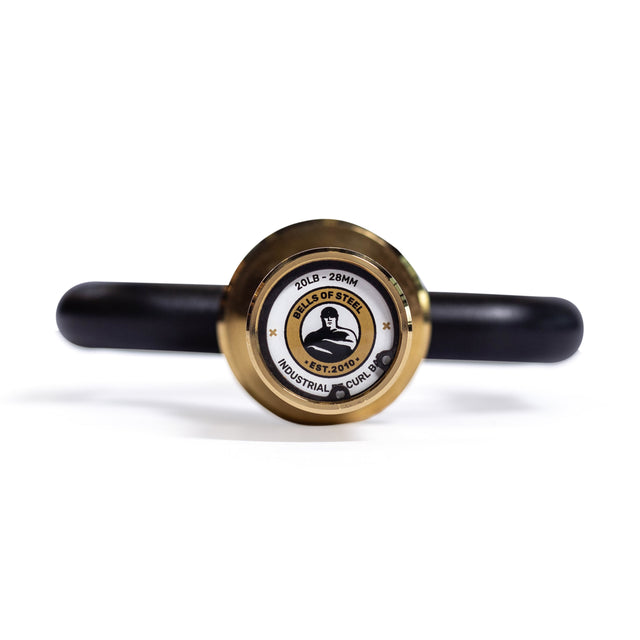 A close-up of the end of a black and gold Bells of Steel Tricep Bar, showing the logo, weight, and specs engraved on the end cap, with ergonomic handles extending back out of focus.