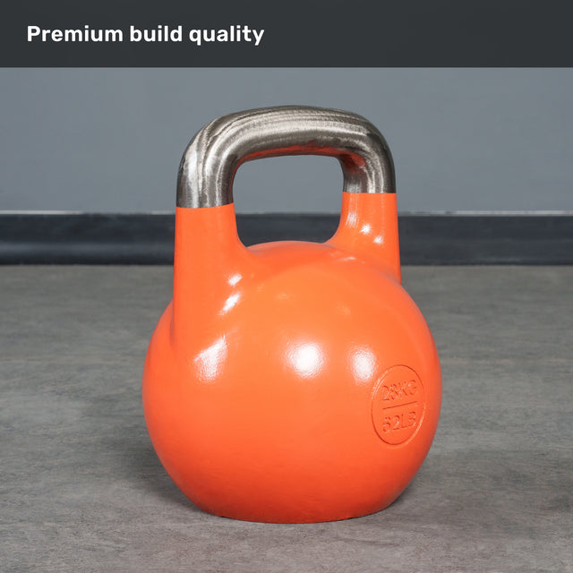 A Bells of Steel Competition Kettlebell with a bright orange finish and a polished metal handle rests on a gray floor, clearly marked “28KG 62LBS.” Bold white text at the top states “Premium build quality.” Like all Competition Kettlebells from Bells of Steel, it maintains an identical size across all weights to ensure consistent performance and grip.