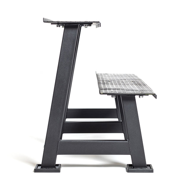 Side view of the Bells of Steel Kettlebell Rack—an industrial-style metal bench with a mesh seat and sturdy, angular legs, ideal as seating or paired with your kettlebell rack—set against a plain white background.