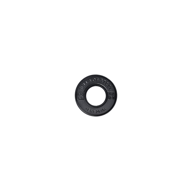 A black circular weight plate from Bells of Steel, labeled "BUILD STRENGTH" and "EST. 2016," features ridged edges and weight details. This Calibrated Powerlifting Plate - KG has standard diameters and a central hole for bar placement, set against a white background.