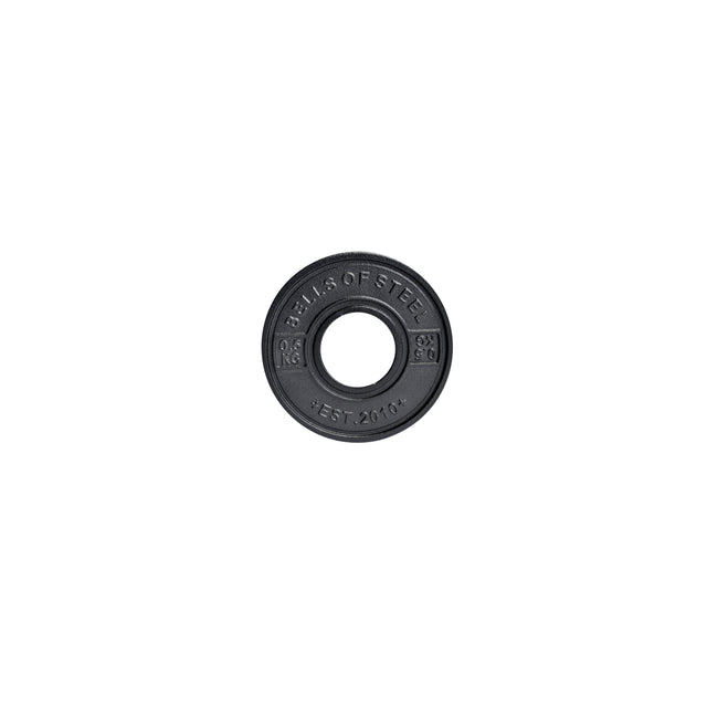 A black circular weight plate with "Bells of Steel" embossed on it is designed to meet IPF specs and features a central hole for bar fitting. With "Est. 2010" on its surface, this Calibrated Powerlifting Plates - KG set is ideal for precise lifting sessions.