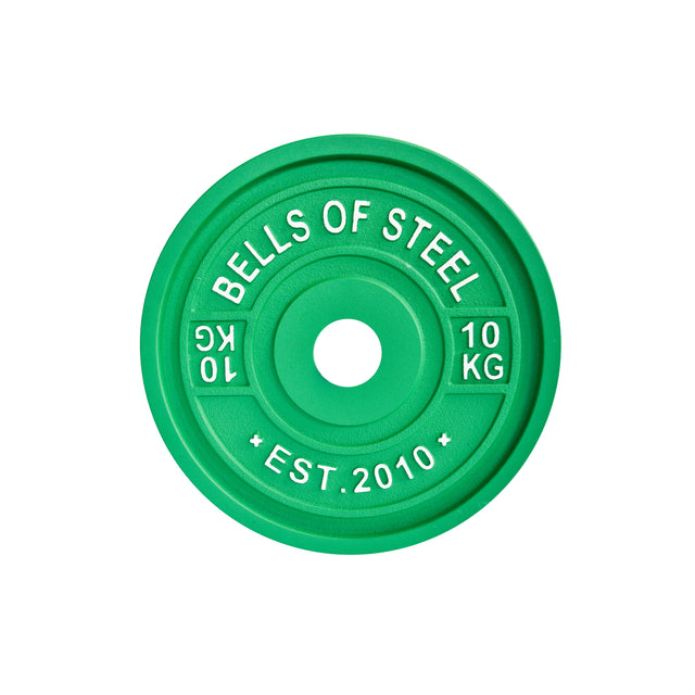 The green Calibrated Powerlifting Plates by Bells of Steel feature white text: "BELLS OF STEEL," "10 KG," and "EST. 2010." They are designed with precision to match standardized diameters typical of powerlifting plates.