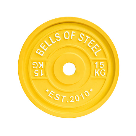 The 15 kg yellow weight plate from Bells of Steel is labeled with "BELLS OF STEEL" and meets IPF specs with standardized diameters. Inscribed with "EST. 2010," it ensures precision for the Calibrated Powerlifting Plates - KG series.