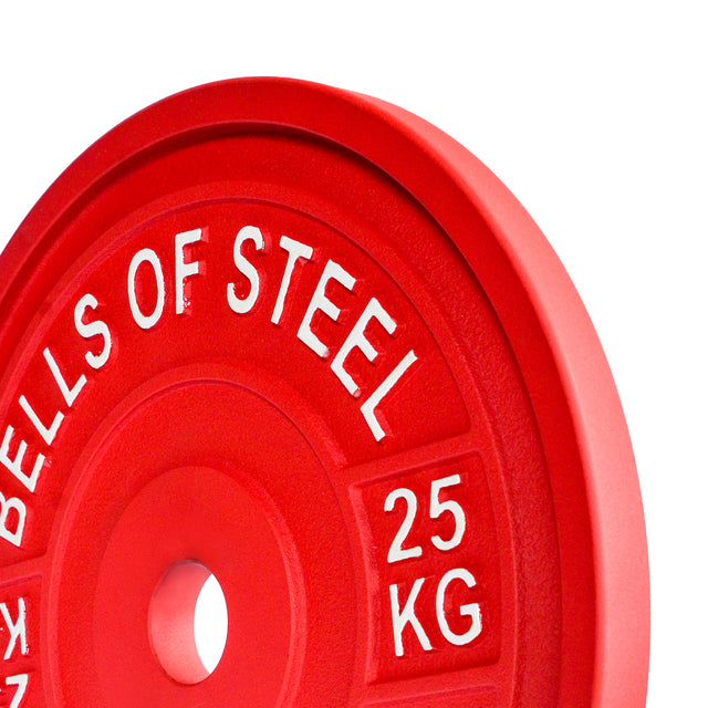 Close-up of a red 25 kg Calibrated Powerlifting Plate by Bells of Steel, featuring raised white text for easy visual identification. This plate complies with standardized diameters and is color-coded for convenient use during workouts.