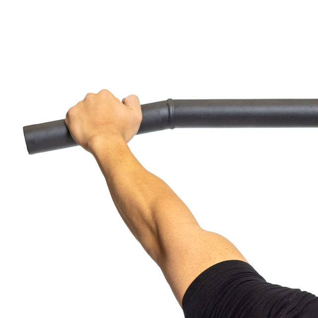 A person grips the Bells of Steel Fat Bar - Lat Pulldown Bar with their left hand, demonstrating grip strength against a plain white background.