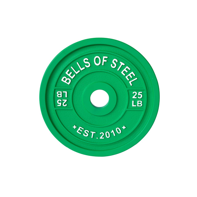 The green "Calibrated Powerlifting Plates - LB" by Bells of Steel, expertly feature "BELLS OF STEEL," "25 LB," and "EST. 2010." They have a precise central hole for seamless barbell fitting, designed as training plates.