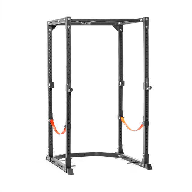 The Bells of Steel Light Commercial Power Rack (2.3" x 2.3", ⅝" holes) in black is pictured with multiple adjustment points and two orange safety straps, making it ideal for home weightlifting setups against a white background.