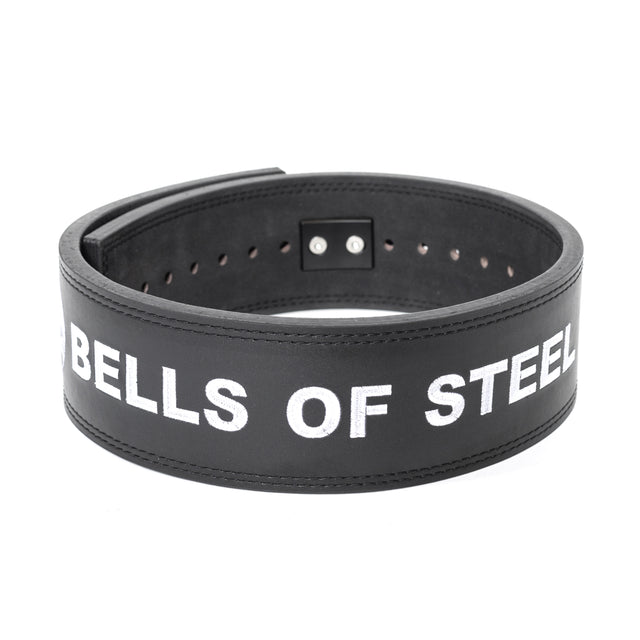 The Bells of Steel Lever Belt is a black leather powerlifting belt with white "BELLS OF STEEL" text, visible buckle holes and stitching, coiled to show durability—ideal for heavy training.