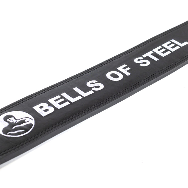 Close-up of the Bells of Steel Lever Belt in black, featuring white embroidered "BELLS OF STEEL" text and a flexed arm logo.