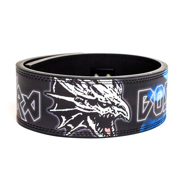 The Bells of Steel Lever Belt is a black lifting belt with a white dragon head graphic and bold white and blue angular text on the front—ideal for serious powerlifting.