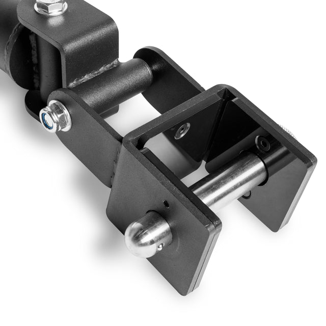 Close-up of a Bells of Steel Landmine Rack Attachment, black metal with a cylindrical rod and two rectangular frames. Visible bolts on the clamp for secure attachment, ideal for strength workouts with an Olympic barbell. Displayed on a white background.