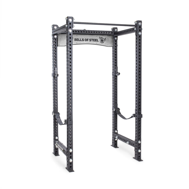The Manticore Four Post Power Rack - Prebuilt by Bells of Steel features 3"x3" uprights, 1" holes for multiple adjustments, two safety straps, a pull-up bar, and a branded frame—ideal for any home gym.