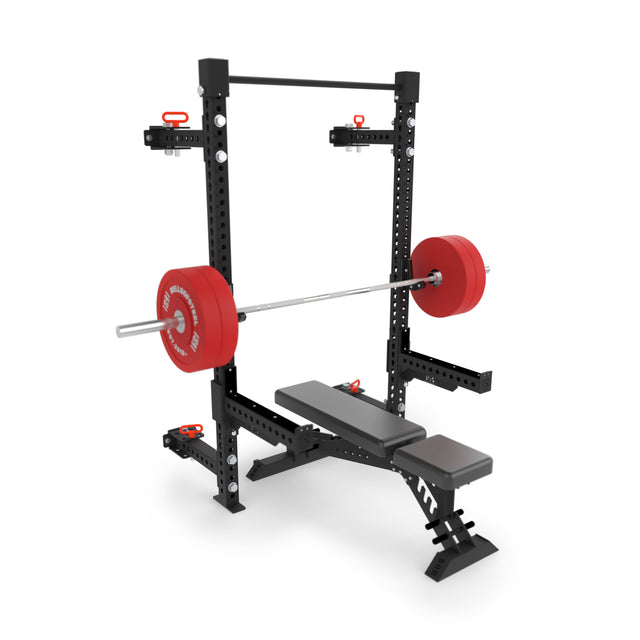 The Bells of Steel Manticore Folding Half Rack (3"x3", 1" holes), shown in black and red with an adjustable bench and red weight plates, is ideal modular gym equipment for home weightlifting and strength training.