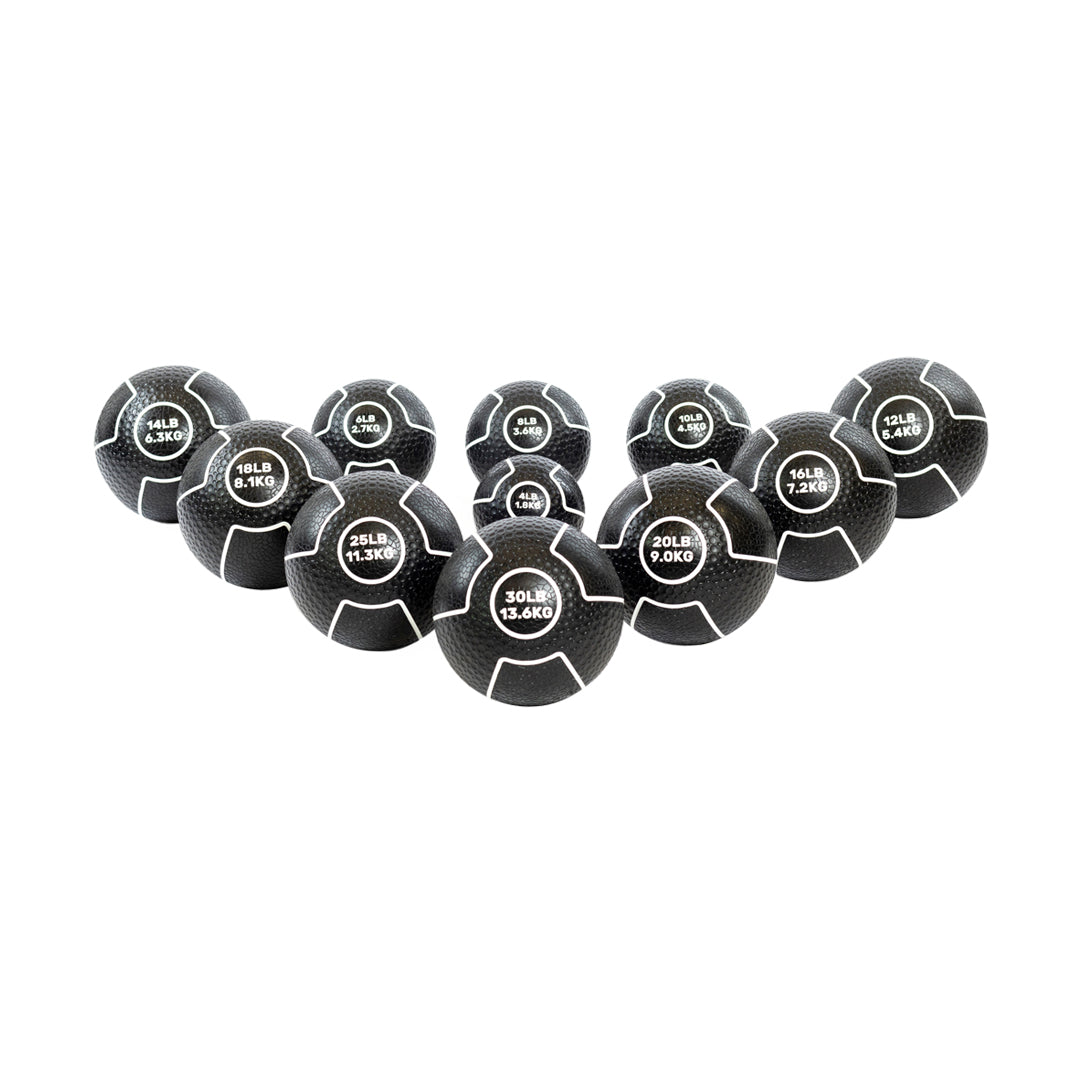 Introducing the Bells of Steel Mighty Grip Medicine Balls, a set of black exercise balls with exceptional grip and diverse weights, labeled in both pounds and kilograms. These balls are arranged in a V-shape gradient to increase size towards the center, meeting all fitness levels.