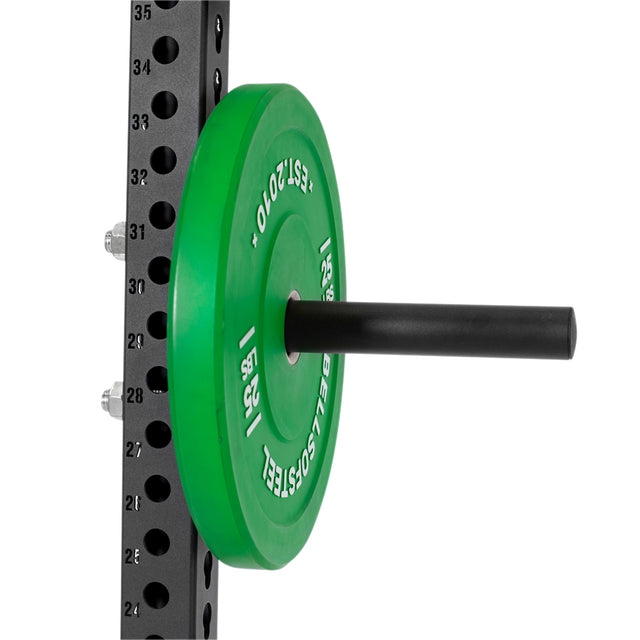 A Bells of Steel Bolt-On Plate Peg Set holds a green "15 KG" weight plate on a horizontal peg attached to a numbered vertical gym rack, offering convenient plate storage.