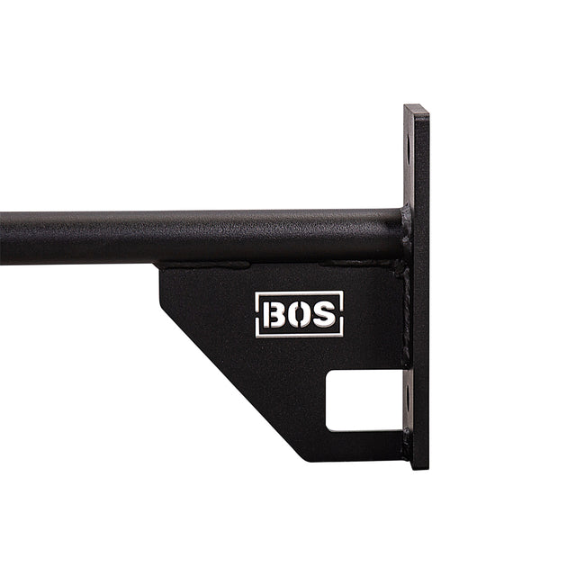 A close-up of a black metal wall bracket for the Bells of Steel 70" Pull Up Bar, featuring the BOS logo in white. The bracket has a flat mounting plate with screw holes and a horizontal support bar, ideal for sturdy setups.