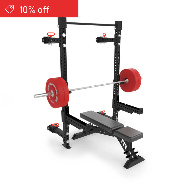 The Bells of Steel Manticore Folding Half Rack Builder (3"x3", 1" holes) with a black bench and a loaded barbell with red plates stands on a white background. A red banner in the top left corner shows "10% off.