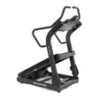 The Blitz Mountain Climber Treadmill by Bells of Steel is a sleek black, manual treadmill with a curved surface and sturdy handlebars. Ideal for cardio enthusiasts seeking an incline experience, it features yellow branding on the side and "BELLS OF STEEL" printed on the base against a white background.