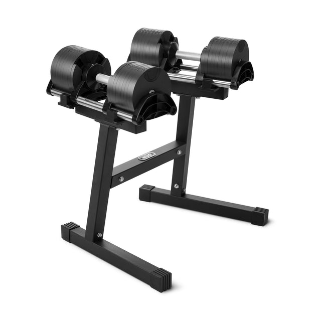 A pair of Nuobell Adjustable Dumbbells sits on the NÜOBELL Floor Stand, a compact and sturdy storage solution by Nuobell, displayed against a plain white background.