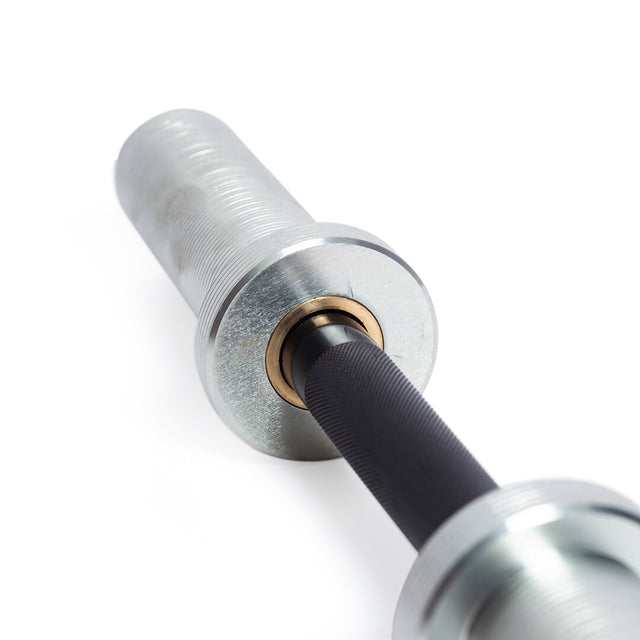 Close-up of the Bells of Steel Loadable Dumbbell Handle featuring a needle bearing and black textured bar, set against a white background—ideal for any home gym or serious workout setup.