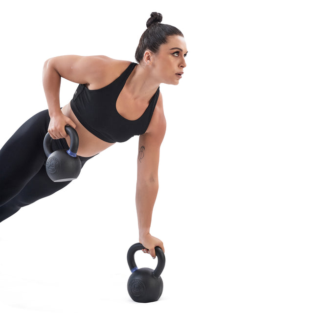 A woman in black athletic wear performs a row exercise, balancing on one arm and one leg, using Bells of Steel Powder Coated Kettlebells against a white background.