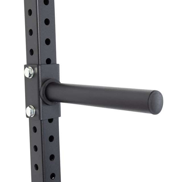 Close-up of the Bells of Steel Wall-Mounted Plate Storage Rack attached to a gym wall, offering adjustable height with multiple holes—ideal for keeping your home gym organized and storing weight plates efficiently.