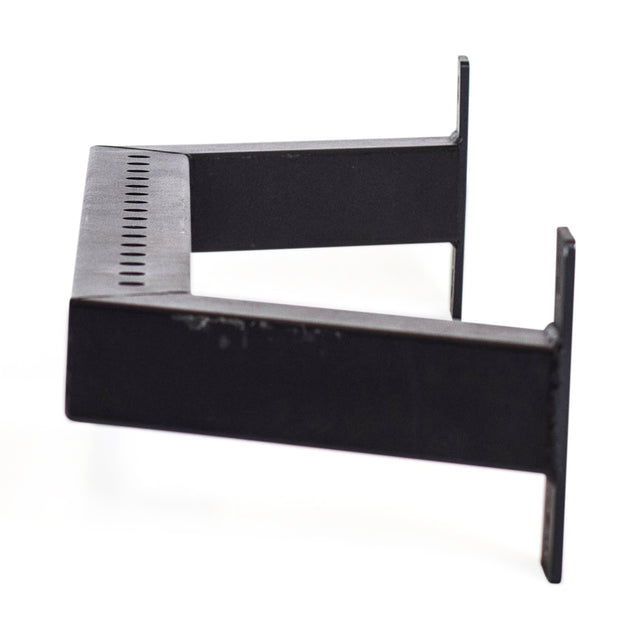 The Bells of Steel Rear Base Stabilizer is a black metal bracket with a rectangular frame, angled sides, and a row of small holes along the top edge, designed for 3x3 power rack uprights and shown against a white background.