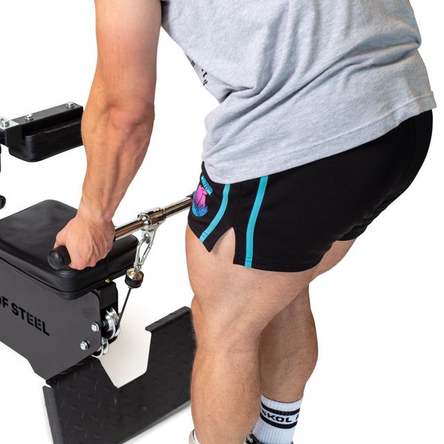Wearing athletic gear, a person grips the Bells of Steel Straight Bar Cable Attachment (20") on a seated row machine, showcasing their arm, shorts, and strong legs as they get ready to exercise.
