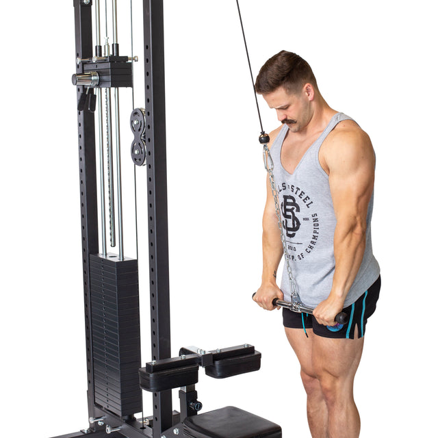 A man wearing a gray tank top and black shorts performs a triceps pushdown on a cable machine, gripping the Bells of Steel Straight Bar Cable Attachment (20") with both hands while standing upright.