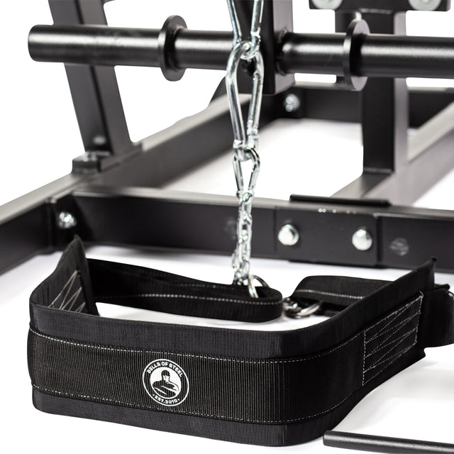 Close-up of a black weightlifting belt, perfect for use with the Bells of Steel Reverse Hammer 2 In 1 GHD And Reverse Back Extension. It has a chain attachment, front logo, and metal hardware for secure fastening, ideal for boosting your posterior chain strength.