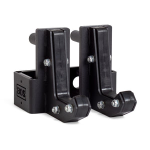 Two black metal Sandwich J-Cups by Bells of Steel with bolts and a rectangular base, designed as heavy-duty squat rack attachments. The BOS logo appears on the side of one holder.