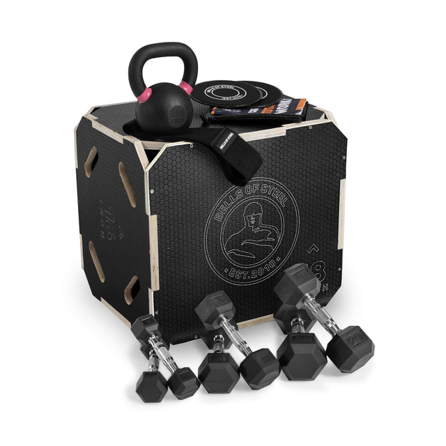 The Bells of Steel Strength Circuit Starter Kits include a black plyometric box, kettlebell, dumbbells, resistance bands, and workout booklets—perfect for home workouts and shown neatly arranged on a white background.