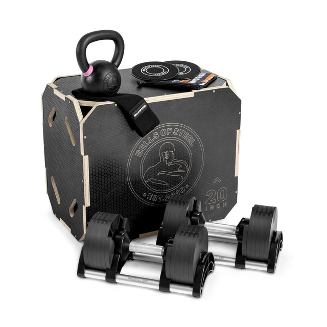 The Bells of Steel Strength Circuit Starter Kits, featuring adjustable dumbbells, a black kettlebell, resistance bands, weight plates, and a 20-inch plyometric box, create an ideal home workout setup.