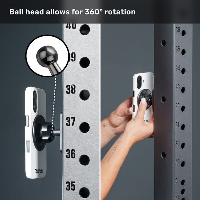 Close-up of a phone mounted on a metal rack using the Bells of Steel USA Selfie Sentinel - Magnetic Rack Phone Holder, featuring a ball head that enables full 360° rotation. Text at the top reads, “Ball head allows for 360° rotation.” Ideal as a versatile phone mount or gym tripod accessory.