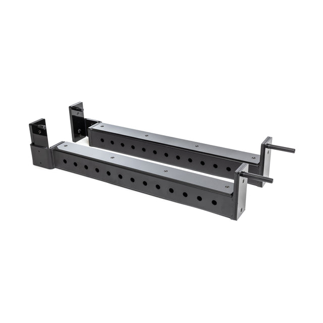 The Bells of Steel Flip-Down Safeties are two metal rectangular bars with evenly spaced holes, bracket mounts, and pins on one side, designed as adjustable safety supports for gym power rack training.