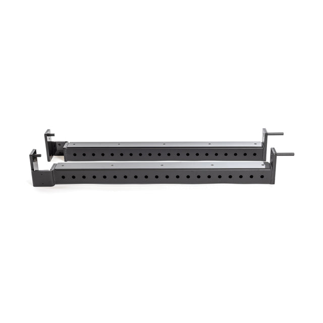 The Bells of Steel Flip-Down Safeties are two long black metal brackets with multiple holes and pins, positioned parallel on a white background, designed for improved training safety in your power rack.