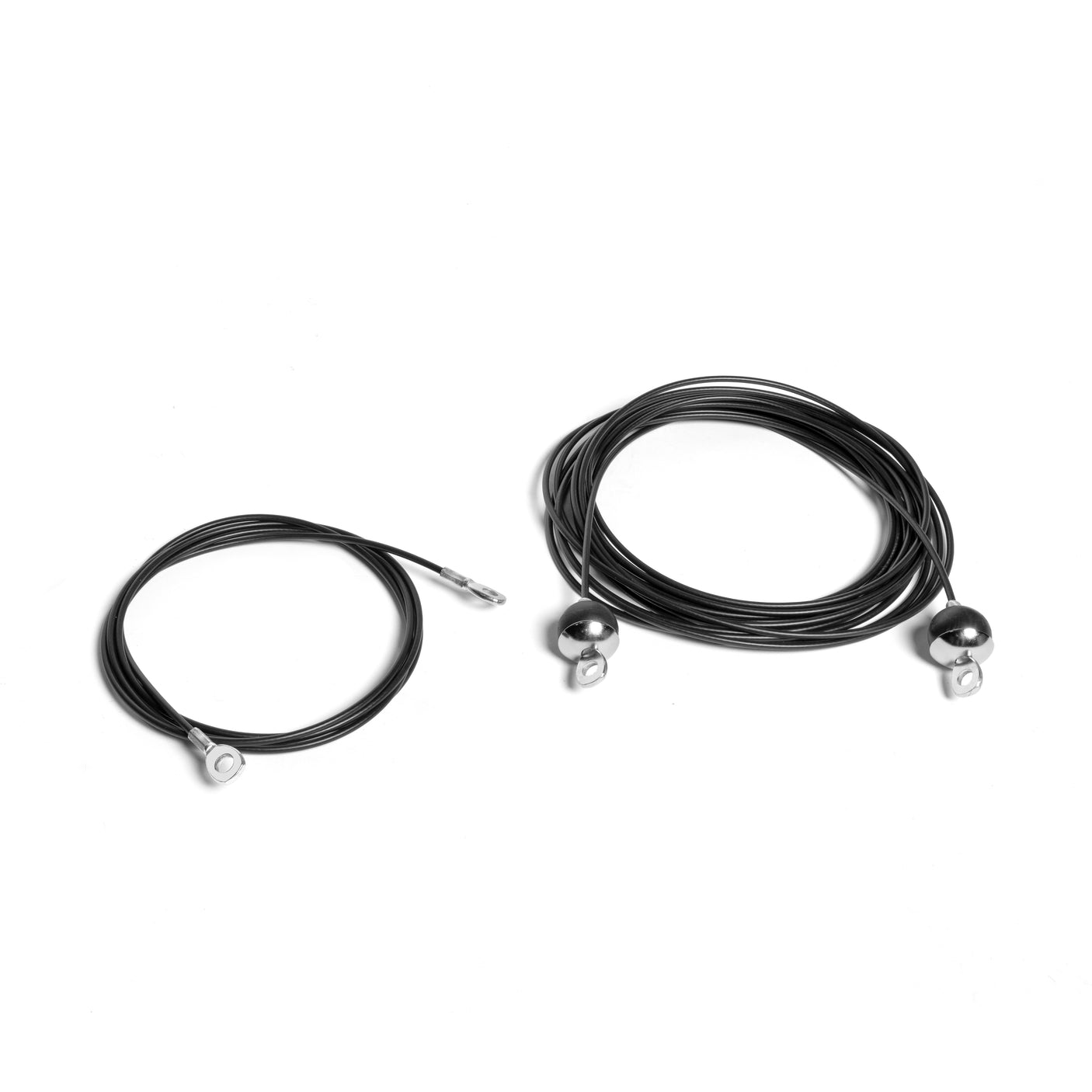 Two coiled cables, one smaller and one larger, rest on a white background. They have metallic ends for attachment, similar to those on the advanced TPU cables from Bells of Steel USA's Cables for Weight Stack Cable Tower.