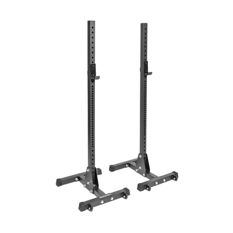 Bells of Steel Squat Stands (2.3" x 2.3", ⅝" holes) are black, freestanding with adjustable barbell holders and wide bases—ideal for home gyms or weightlifting clubs—shown on a white background.