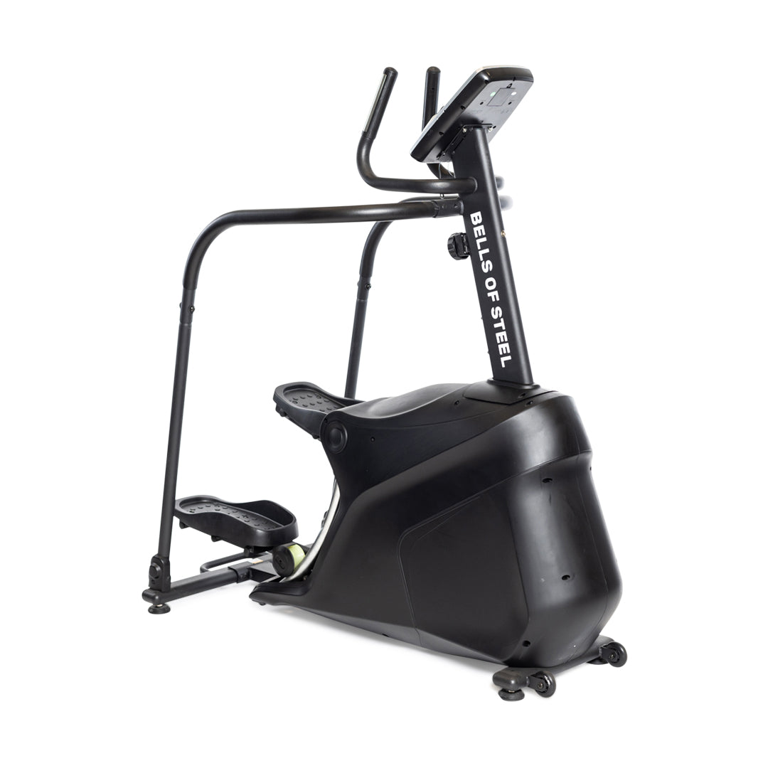 The Blitz Stepper by Bells of Steel is a black exercise machine with handlebars, foot pedals, and a digital display, designed for low-impact indoor stair climber cardio workouts.