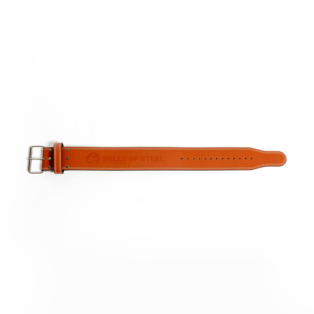 A Bells of Steel USA 10mm Leather Weightlifting Belt in brown, featuring white stitching and a silver buckle, is laid flat on a white background.